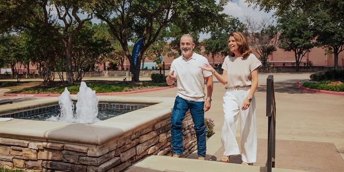 senior couple walking by fountain