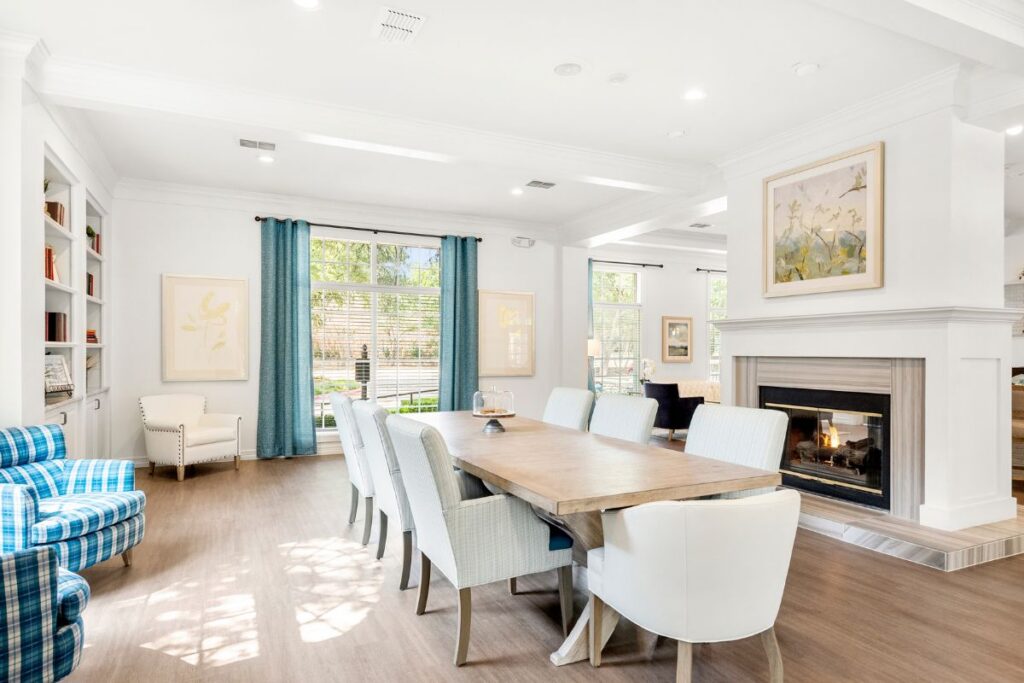 The Oaks at Plano long table and seating next to fireplace