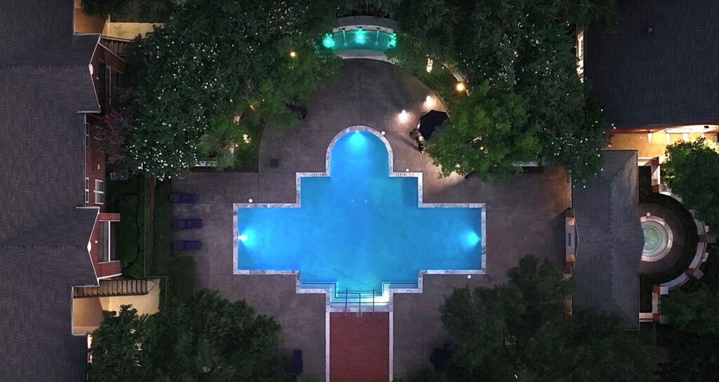 The Oaks at Plano outdoor pool lit for nighttime swimming