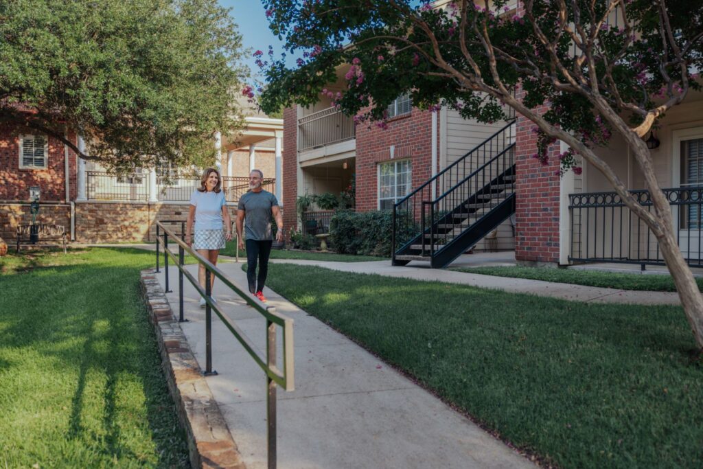 senior friends walking through community